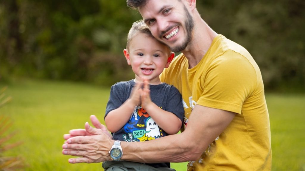 Father and son smiling outdoors