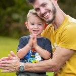 Father and son smiling outdoors
